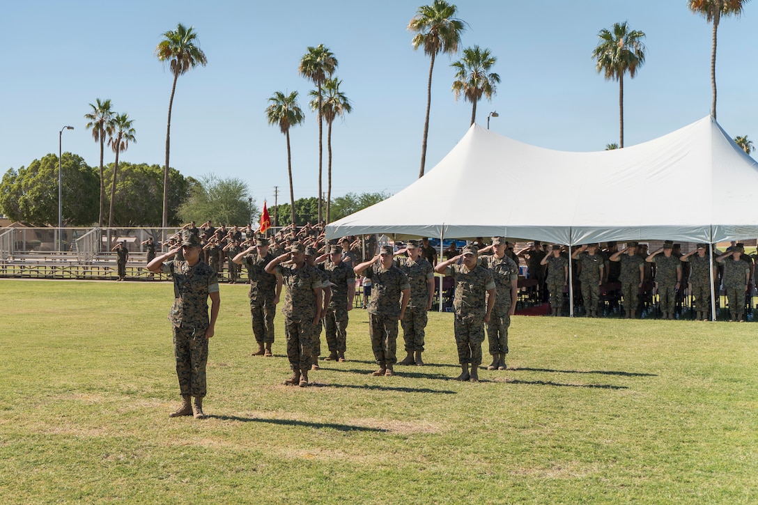 U.S. Marines salute colors while the National Anthem plays on Marine Corps Air Station Yuma, Ariz., June 11, 2021.