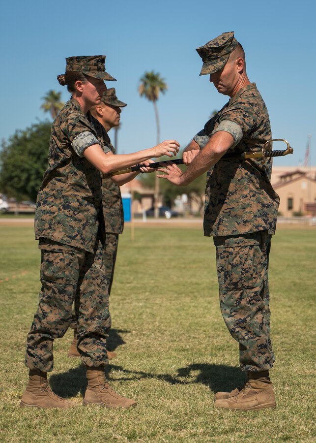 U.S. Marine Corps Lt. Col. Andrea Goeman passes the sword to Master Gunnery Sgt. Leon Harpel on Marine Corps Air Station Yuma, Ariz., June 11, 2021.