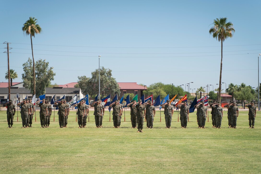 U.S. Marines from Marine Wing Support Squadron 371 salute while the national anthem plays during a change of command ceremony on Marine Corps Air Station Yuma, June 8, 2021.