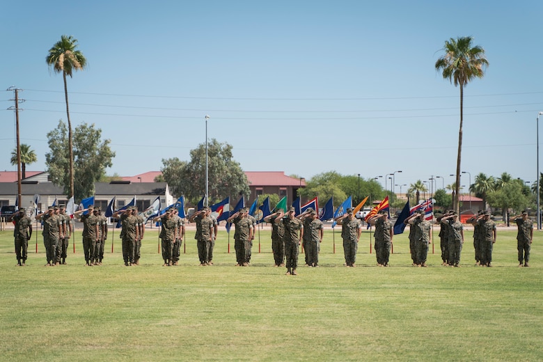 U.S. Marines from Marine Wing Support Squadron 371 salute while the national anthem plays during a change of command ceremony on Marine Corps Air Station Yuma, June 8, 2021. The ceremony marks a change in leadership and the continuation of the unit's effectiveness. (U.S. Marine Corps photo by Lance Cpl. Carlos Kealy)