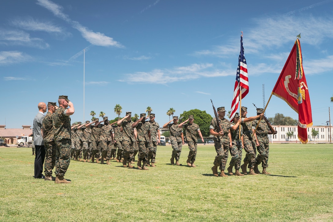 U.S. Marines from Marine Wing Support Squadron (MWSS) 371 salute U.S. Marine Corps Lieutenant Colonel Aaron Norwood as they march by on Marine Corps Air Station Yuma, June 8, 2021.