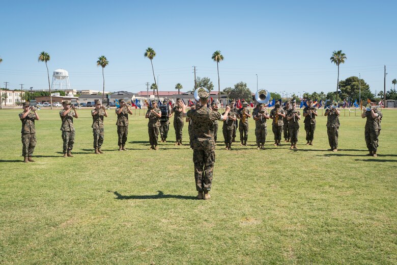 U.S. Marine Corps Staff Sgt. John Geary conducts the 3rd Marine Aircraft Wing Band during a change of command ceremony on Marine Corps Air Station Yuma, June 8, 2021. The ceremony marks a change in leadership and the continuation of the unit's effectiveness. (U.S. Marine Corps photo by Lance Cpl. Carlos Kealy)