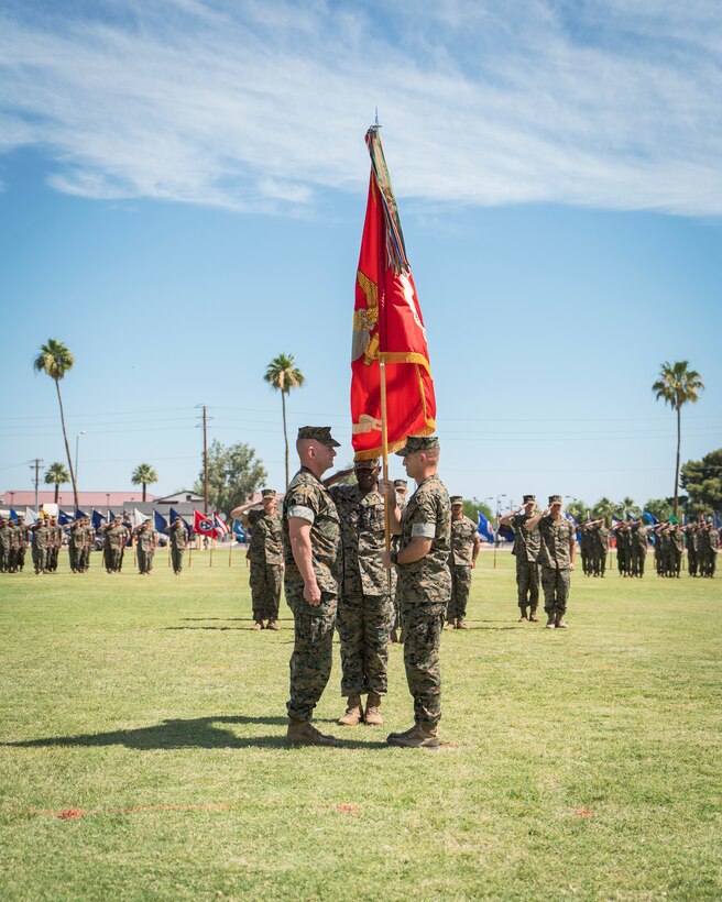 U.S. Marine Corps Lt. Col. Nicholas Lozar passes the U.S. Marine Corps flag to Lt. Col. Aaron Norwood on Marine Corps Air Station Yuma, June 8, 2021. The passing of colors is performed at change of command ceremonies to symbolize the passing of command from one officer to the other. (U.S. Marine Corps photo by Lance Cpl. Carlos Kealy)