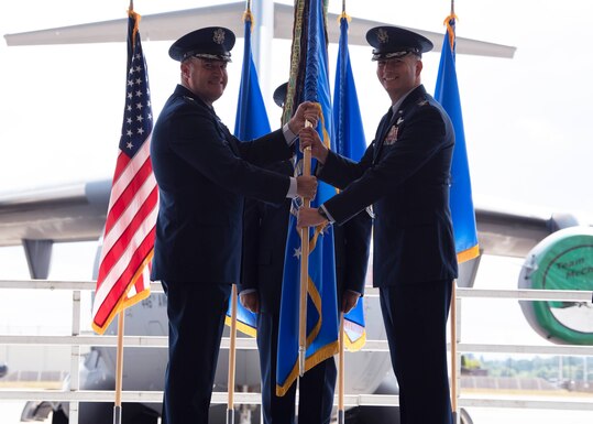 U.S. Air Force Maj. Gen. Kenneth T. Bibb Jr., 18th Air Force commander, presents Col. David A. Fazenbaker, 62nd Airlift Wing commander, with the 62nd AW’s guidon during a change of command ceremony at Joint Base Lewis-McChord, Washington, June 15, 2021. Prior to taking command of the 62nd AW, Fazenbaker was the 14th Flying Training Wing vice commander at Columbus Air Force Base, Mississippi. (U.S. Air Force photo by Senior Airman Zoe Thacker)