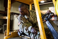 Alaska Army Guard Sgt. Shanun Seymore, United States Property and Fiscal Offices Supply Support Activity, operates a forklift to move freight for final processing at the USPFO warehouse on Joint Base Elmendorf-Richardson, June 7, 2021. (U.S. Army National Guard photo by Victoria Granado)