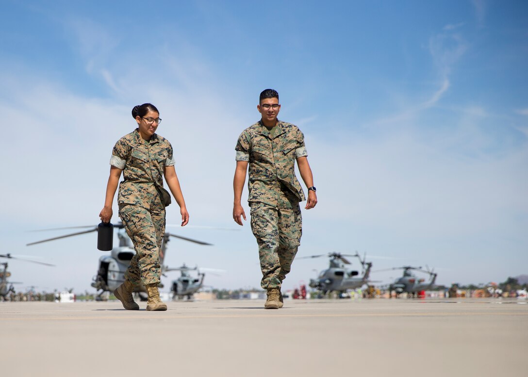 U.S. Marine Corps Lance Cpl. Gabriela Rodriguez, Left, and Cpl. Victor RuizVazquez, with Headquarters and Headquarters Squadron, survey the area during the Foreign Object Debris (FOD) walk at Marine Corps Air Station Yuma, Ariz., June 7, 2021. A FOD walk is conducted routinely to make sure runways are clear from debris that may damage aircraft using it. (U.S. Marine Corps Photo by Lance Cpl Matthew Romonoyske-Bean)