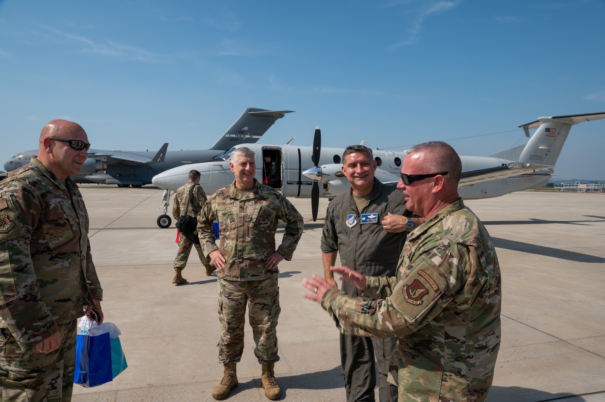 The U.S. Air Force Expeditionary Center Command Chief, Chief Master Sgt. Anthony Green, left, The U.S. Air Force Expeditionary Center Commander, Maj. Gen. Mark Camerer, middle left, Col. John Gonzales, 51st Fighter Wing commander, middle right, and Chief Master Sgt. Justin Apticar, 51st Fighter Wing command chief, right, give farewells at Osan Air Base, May 19, 2021. The Expeditionary Center is the Air Force's preeminent authority for expeditionary operations and supports AMC’s worldwide mission of providing Rapid Global Mobility to America’s armed forces. (U.S. Air Force photo by Senior Airman Branden Rae)