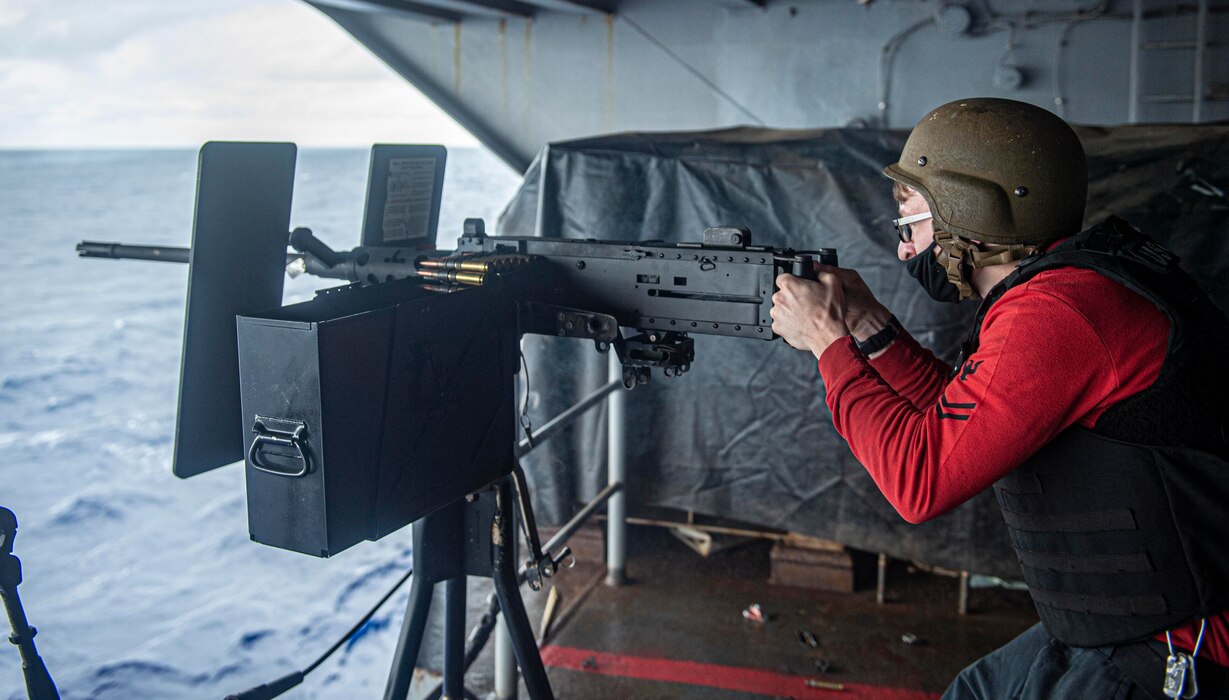 Gunner's Mate 2nd Class Lukas Hanson, from North Branch, Minnesota, aims a .50-caliber machine gun during a live-fire exercise on a weather deck aboard the Nimitz-class aircraft carrier USS Harry S. Truman (CVN 75) during Tailored Ship's Training Availability (TSTA) and Final Evaluation Problem (FEP).