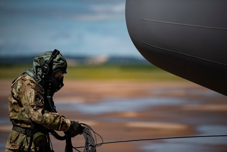 Senior Airman Noah Isom, 39th Airlift Squadron loadmaster, conducts preflight checks on a C-130J Super Hercules while weaning the new Uniform Integrated Protective Ensemble Air 2 Piece Under Garment chemical protective suit at Dyess Air Force Base, Texas, June 2, 2021. Research and development of new protective equipment allows the Air Force to find practical ways to combine functionality, operability and comfortability.