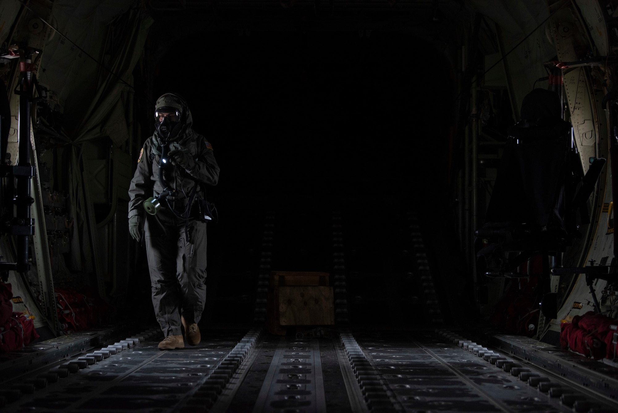 Staff Sgt. Tristan Geray, 40th Airlift Squadron loadmaster, conducts preflight checks in the cargo bay of a C-130J Super Hercules at Dyess Air Force Base, Texas, June 3, 2021. Geray participated in the field testing of the new Uniform Integrated Protective Ensemble Air 2 Piece Under Garment chemical, biological, radioactive and nuclear protective equipment.