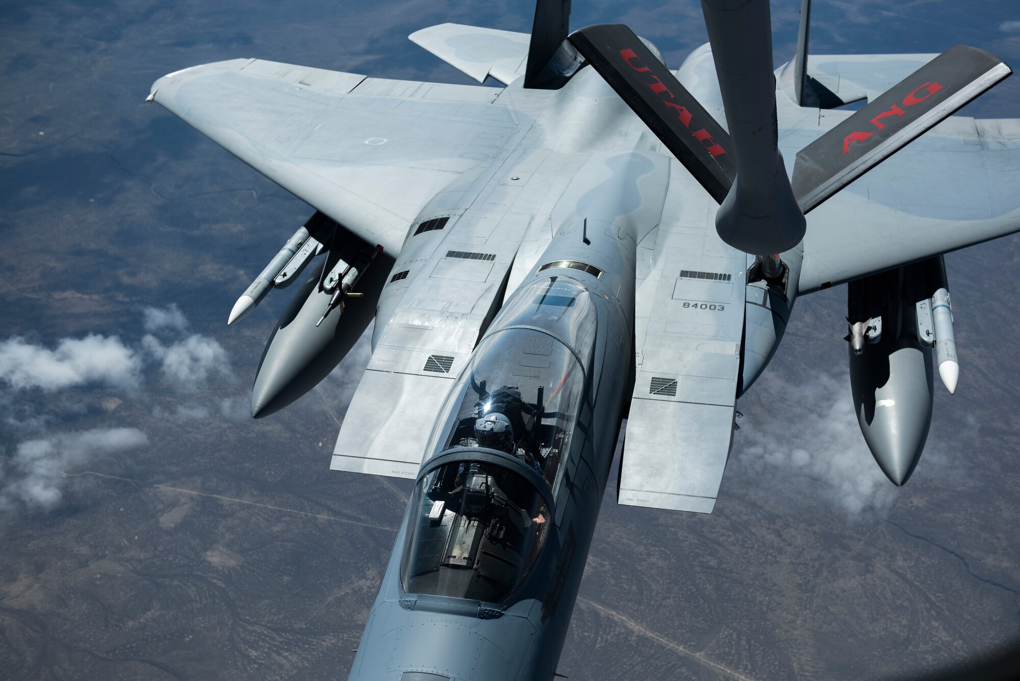 This is a picture of a F-15 jet aircraft in the middle of refueling.