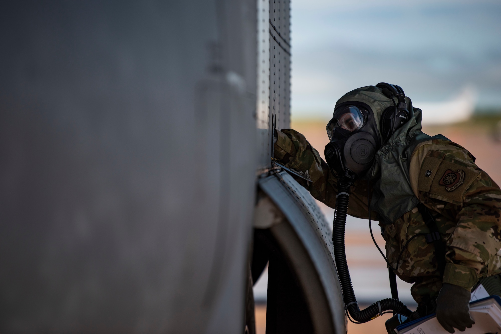 Senior Airman Noah Isom, 39th Airlift Squadron loadmaster, conducts preflight checks on a C-130J Super Hercules at Dyess Air Force Base, Texas, June 2, 2021. Aircrew assigned to the 317th Airlift Wing tested the functionality of the new Two-Piece Undergarment universal integrative ensemble chemical protective suit. (U.S. Air Force photo by Airman 1st Class Colin Hollowell)