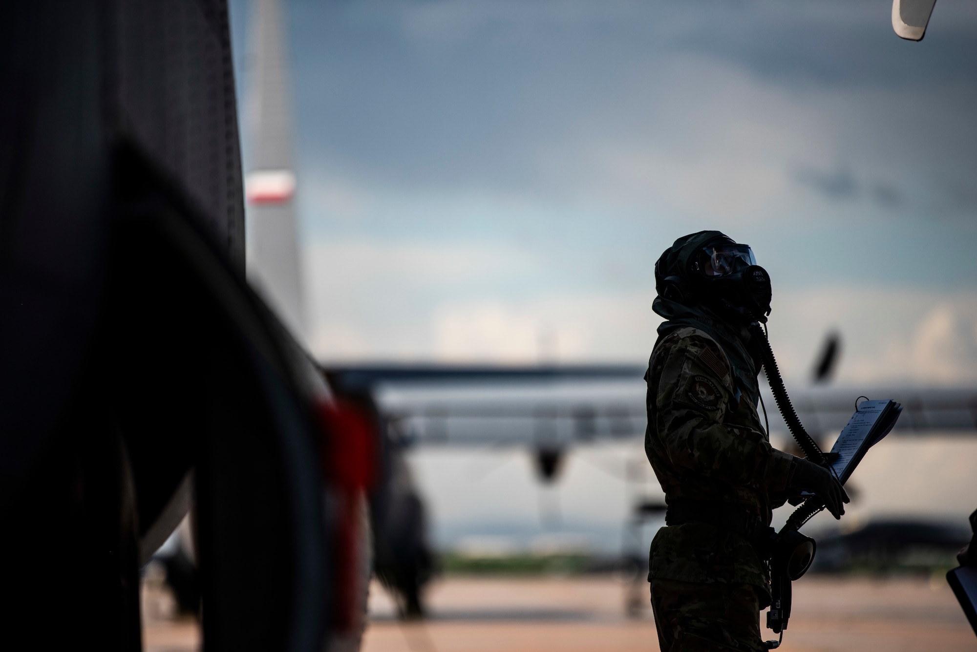 Senior Airman Noah Isom, 39th Airlift Squadron loadmaster, conducts preflight checks on a C-130J Super Hercules at Dyess Air Force Base, Texas, June 2, 2021. Aircrew simulated normal operations while field testing the new Two-Piece Undergarment universal integrative ensemble chemical, biological, radioactive and nuclear protective equipment in order to produce data needed to ensure its operability. (U.S. Air Force photo by Airman 1st Class Colin Hollowell)