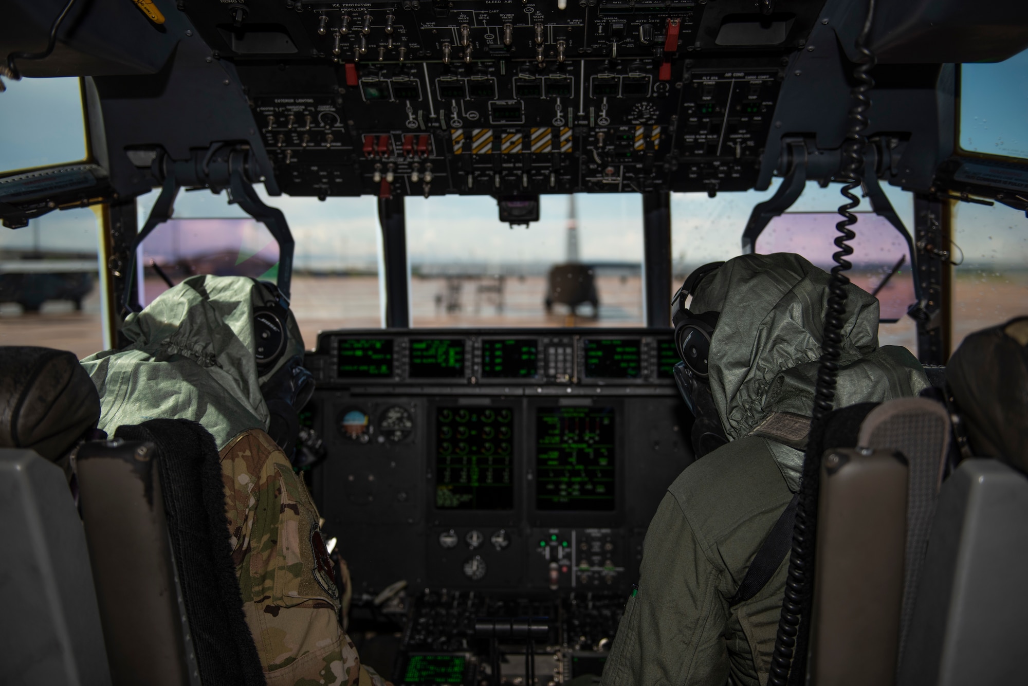 Capt. Miranda Mila, left, and 1st Lt. Coltan Nading, both 40th Airlift Squadron pilots, conducts preflight checks in the cockpit of a C-130J Super Hercules at Dyess Air Force Base, Texas, June 2, 2021. Mila and Nading were part of a four-person team who participated in the functionality testing of the new Two-Piece Undergarment universal integrative ensemble chemical protective suit. During these tests, the C-130 aircrew engaged in standard aircraft preflight and ground egress procedures in order to test the operational ability of the new chemical gear. (U.S. Air Force photo by Airman 1st Class Colin Hollowell)
