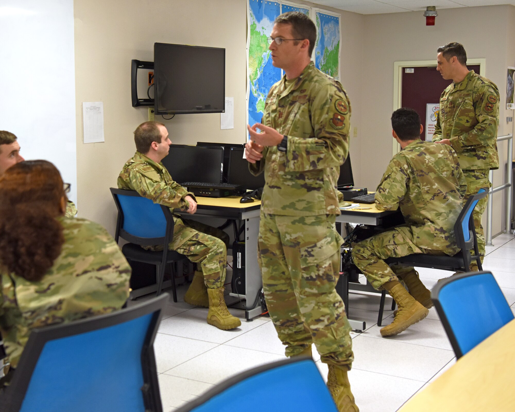 U.S. Air Force Capt. Perry Byrd, 315th Training Squadron instructor, explains concepts to students in the 14N Intelligence Officer course, on Goodfellow Air Force Base, Texas, June 6, 2021. Byrd graduated from the 14N course in 2015 and transferred the course credits towards his master’s degree. (U.S. Air Force photo by Senior Airman Abbey Rieves) *NOTE: This photo has been edited to distort computer classification markers.