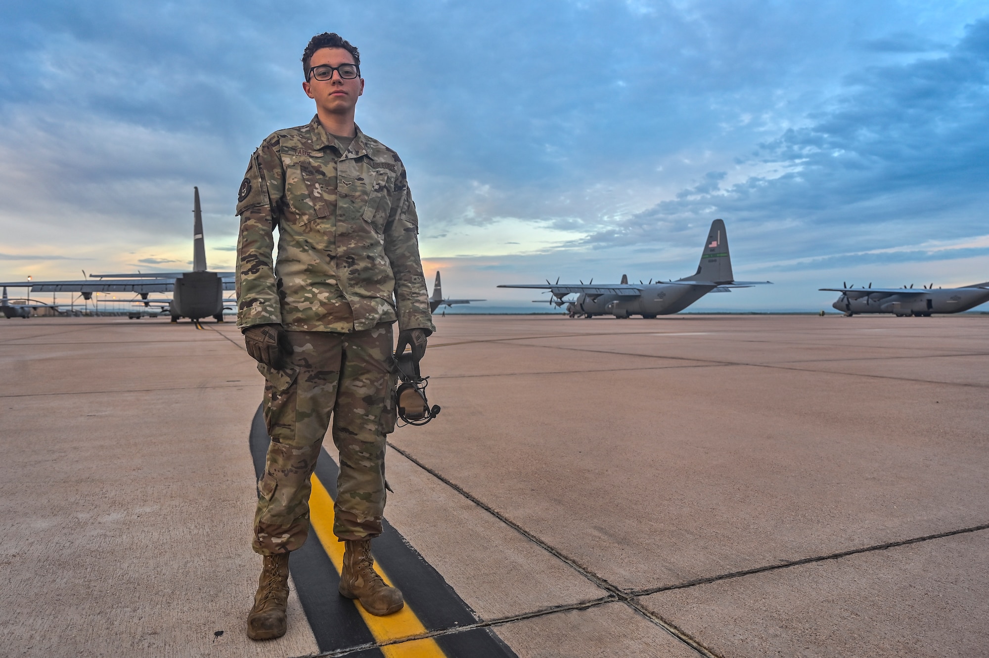 portrait photo of crew chief and C-130s