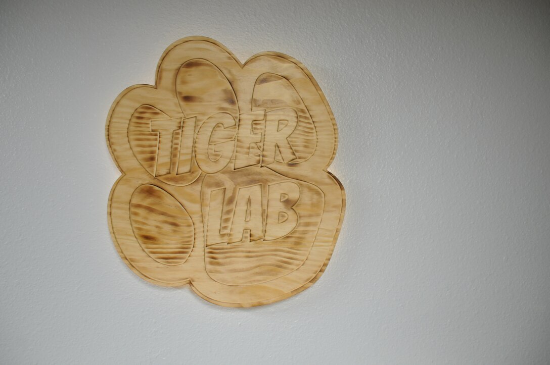 A decorative wood carving is displayed on a wall.