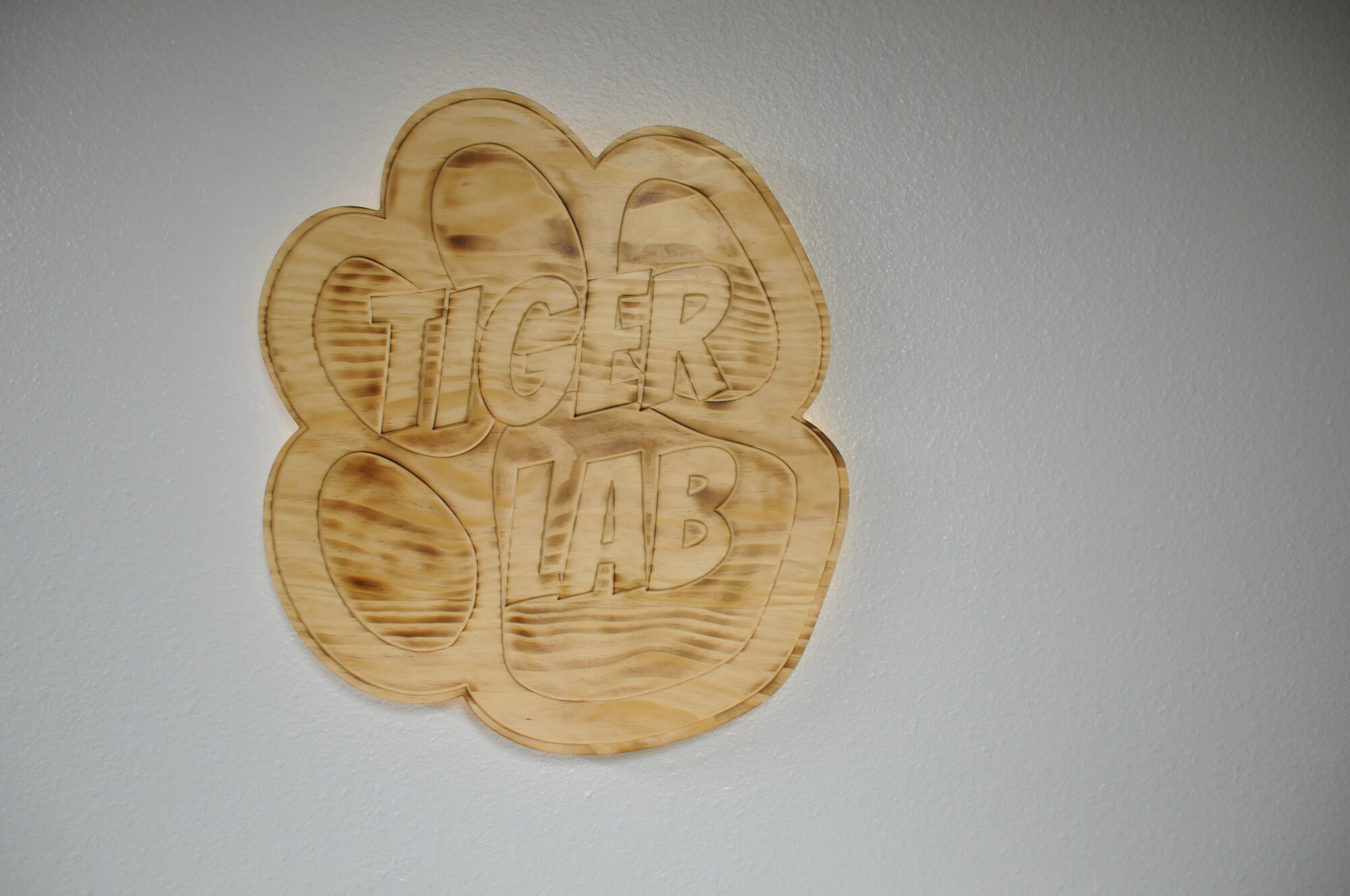A decorative wood carving is displayed on a wall.