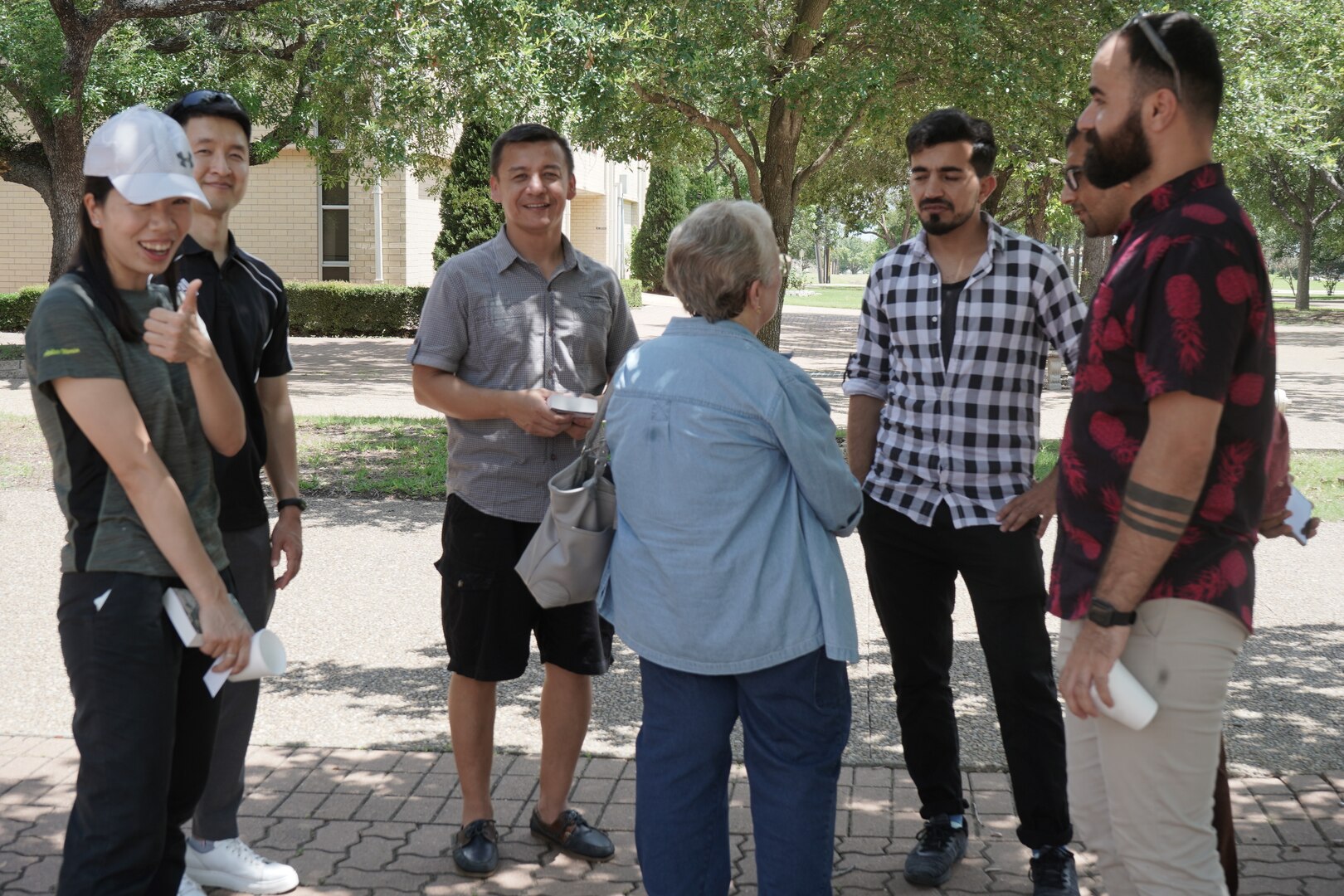 Students talk with AMIGO volunteers outside.