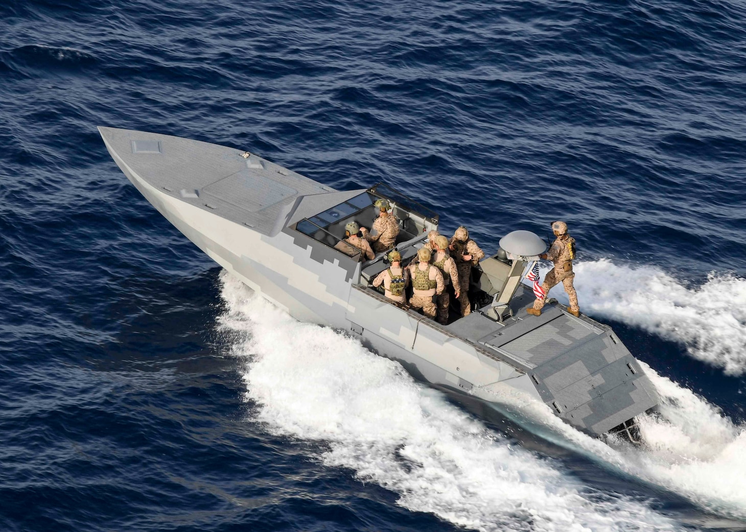 A combatant craft assault craft (CCA) assigned to the Special Boat Team TWENTY, steams alongside the Expeditionary Sea Base USS Hershel "Woody" Williams (ESB 4) in the Mediterranean Sea