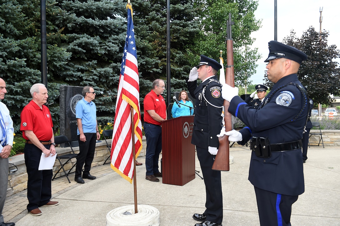 The Buffalo Grove honor guard detail, made up of police officers and fire-fighters from Buffalo Grove, render a salute during a presentation of Colors at the Village of Buffalo Grove annual Flag Day commemoration, June 14, 2021.