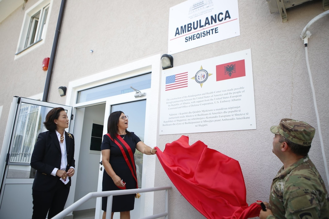 U.S. Ambassador to Albania Yuri Kim looks on as Patos Mayor Rajmonda Balilaj and Chief of the Office of Defense Cooperation at the U.S. Embassy in Tirana Lt. Col. Erol Munir, unveil signage at a ceremony at the two-story kindergarten and health clinic facility in September 2020 where the U.S. Army Corps of Engineers recently completed a major renovation project. The project is a recent example of the kind of humanitarian assistance work the U.S. Army Corps of Engineers does in Albania in close partnership with the U.S. European Command and the U.S. Embassy in Tirana, Albania’s capital. The U.S. Army Corps of Engineers is actively managing several additional projects involving either the construction of new facilities or the renovation of existing facilities to help improve services Albania can provide to its youngest, oldest and most vulnerable citizens.