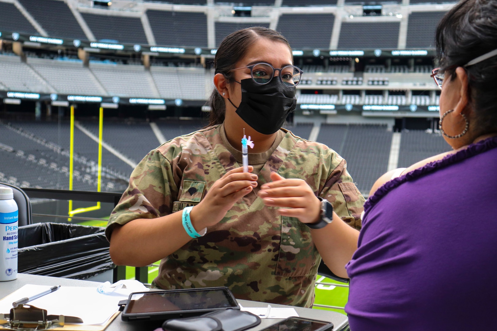 Nevada National Guard Spc. Dulce Alaniz with Joint Task Force 17 prepares to administer the one-shot Janssen vaccine to a citizen at Allegiant Stadium in Las Vegas June 10, 2021. The Nevada Guard is winding down it's 16-month battle against the coronavirus.