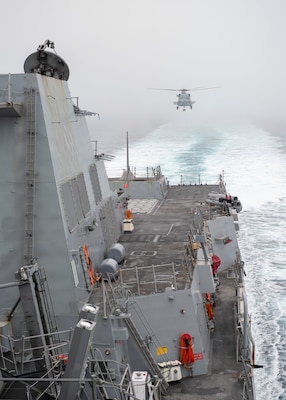 An MH-60R Seahawk, assigned to the “Warlords” of Helicopter Maritime Strike Squadron (HSM-51), conducts a landing maneuver towards Arleigh Burke-class guided-missile destroyer USS Rafael Peralta (DDG 115). Rafael Peralta is assigned to Commander, Task Force 71/Destroyer Squadron (DESRON) 15, the Navy's largest forward-deployed DESRON and U.S. 7th Fleet's principal surface force.