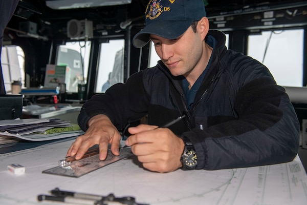 Lt. j.g. Corey Sousa, from Newnan, Ga., plots surface and air contacts as junior officer-of-the-deck during normal underway operations aboard Arleigh Burke-class guided-missile destroyer USS Rafael Peralta (DDG 115). Rafael Peralta is assigned to Commander, Task Force 71/Destroyer Squadron (DESRON) 15, the Navy's largest forward-deployed DESRON and U.S. 7th Fleet's principal surface force.