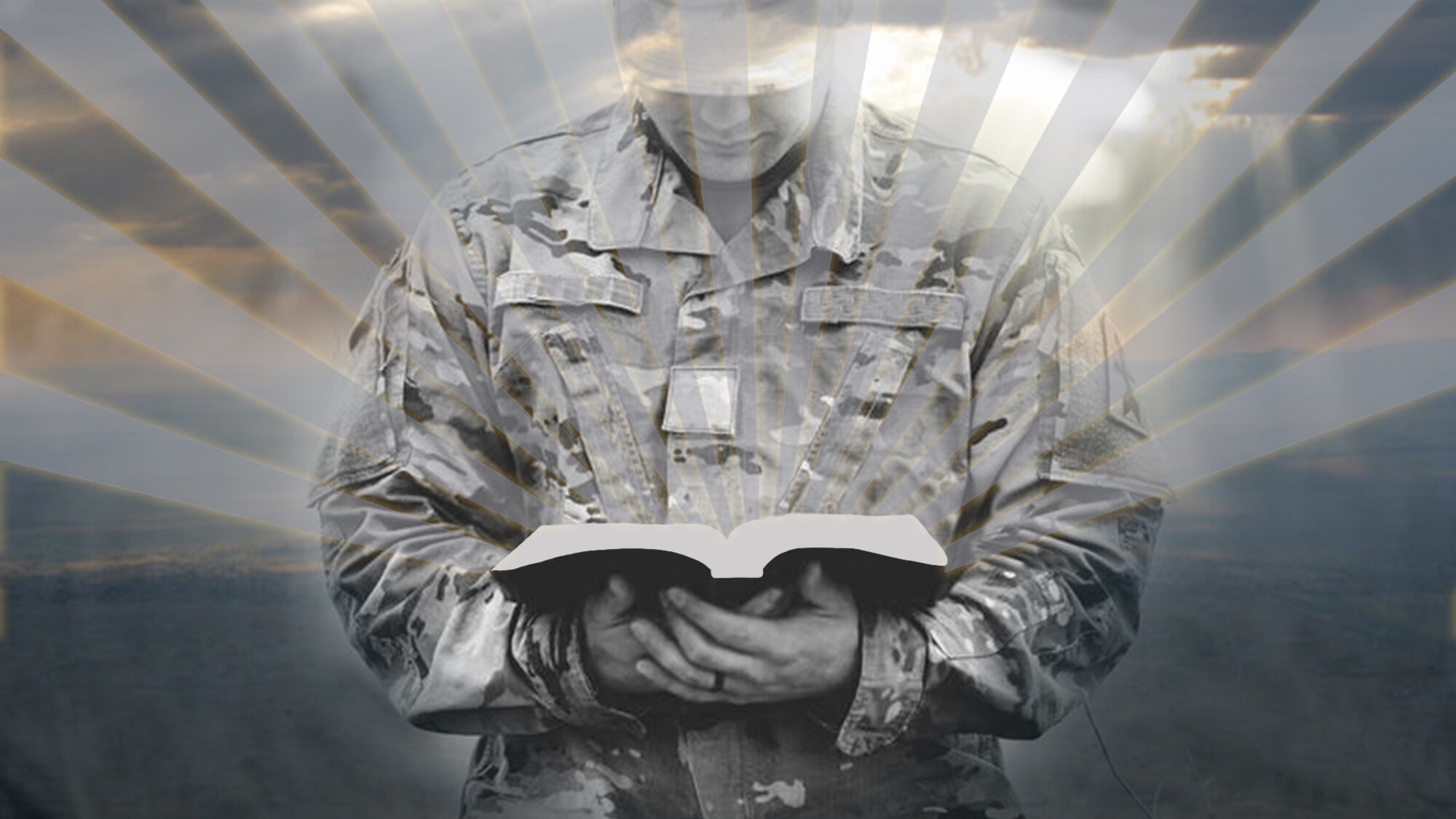 Picture of servicemember holding a book that has rays of sunshine extending out from it.