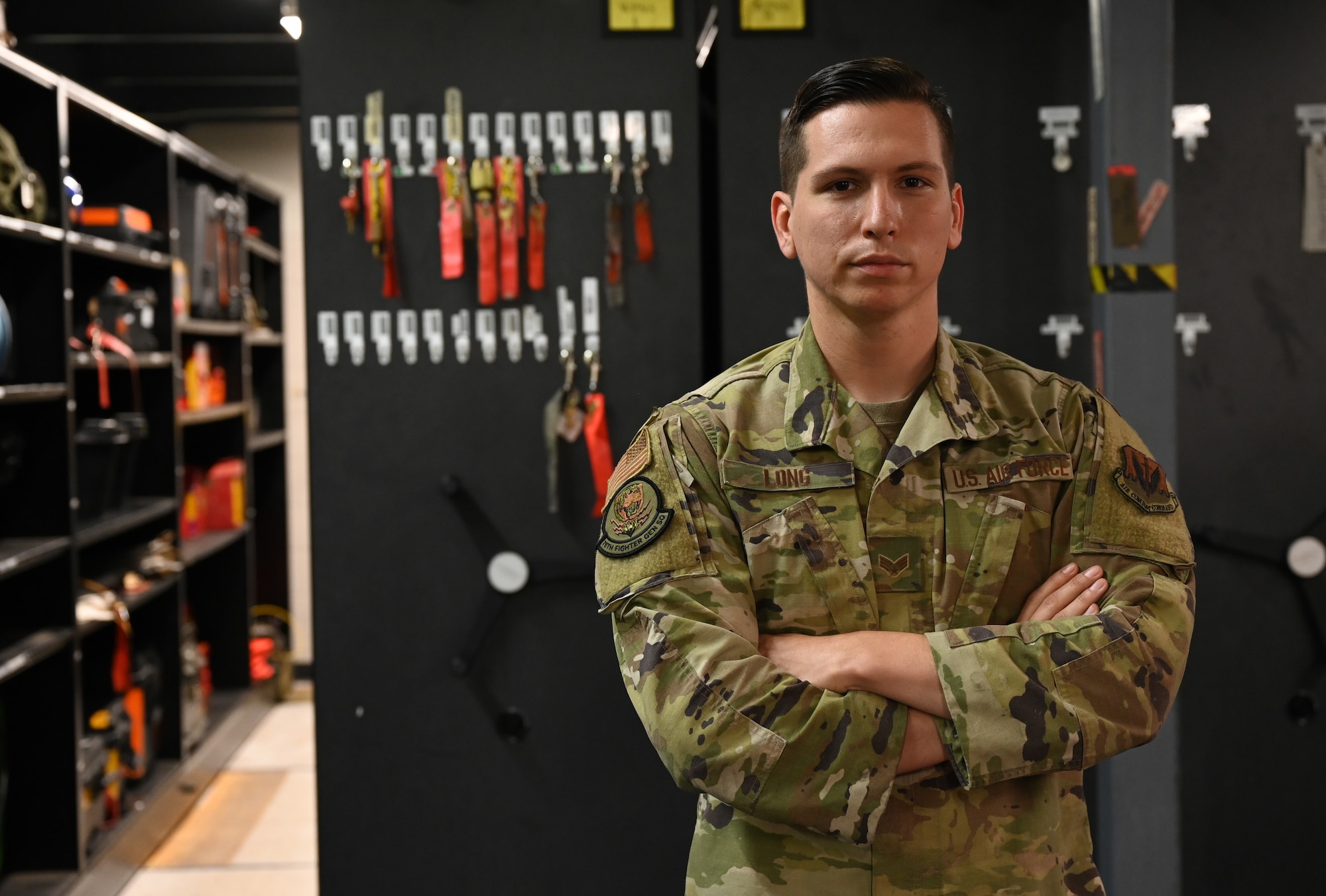 A photo of Senior Airman Timothy Long posing in front of equipment.