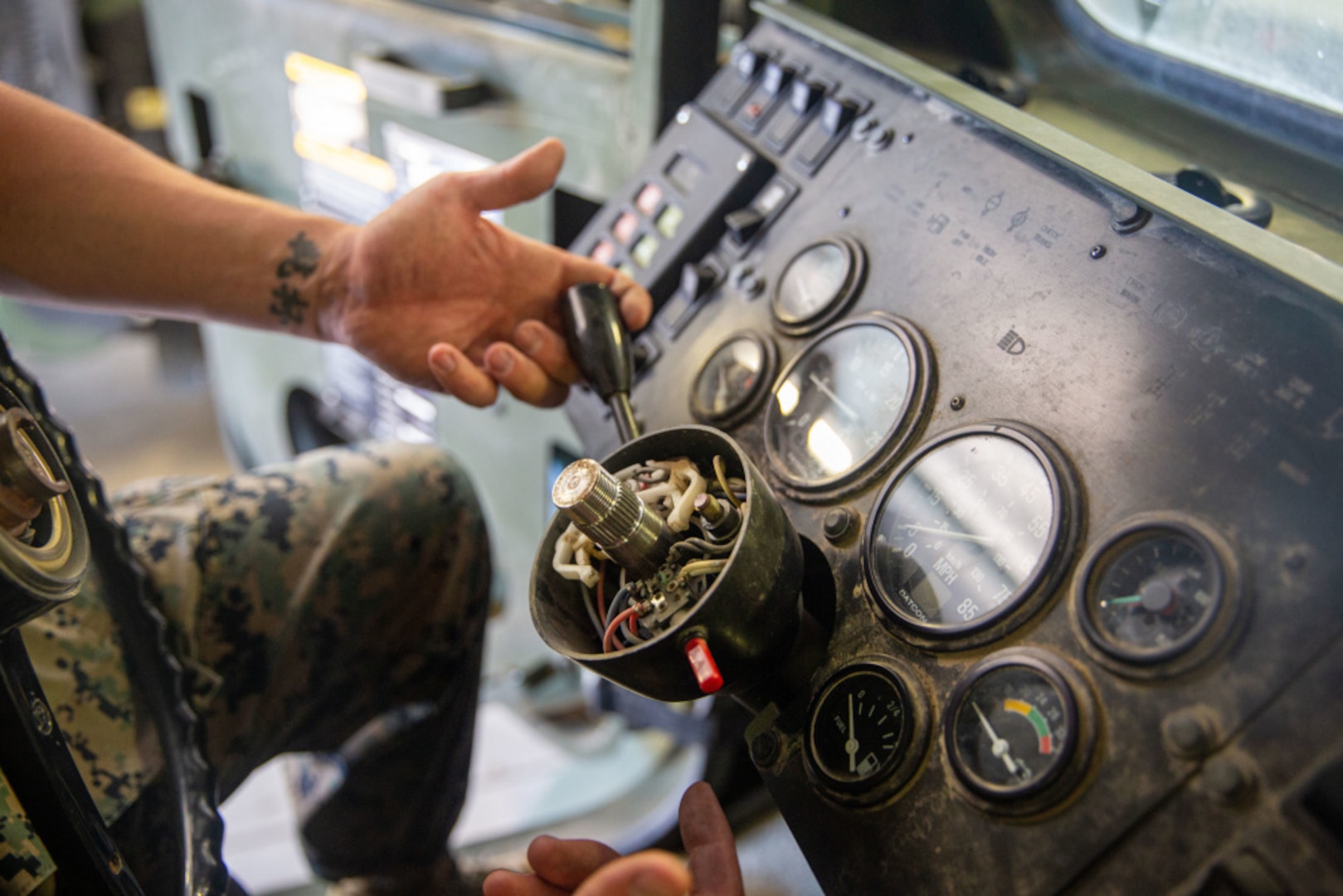 Staff Sgt. Kyle Owens, a motor transportation chief with Combat Logistics Battalion 5, 1st Marine Logistics Group, I Marine Expeditionary Force, shows the wire housing found inside that steering wheel column of the Medium Tactical Vehicle Replacements at Marine Corps Base Camp Pendleton, April 29, 2021. When troubleshooting lighting issues, mechanics are often required to remove the steering wheel to access the wiring. Traditionally, a 10-way slide hammer kit is used to remove the wheel, often cracking the column or warping the wheel in the process. Owens designed a tool that prevents any damage to the truck while removing the steering wheel that won him an Operational Agility Team award for the Innovation Challenge.