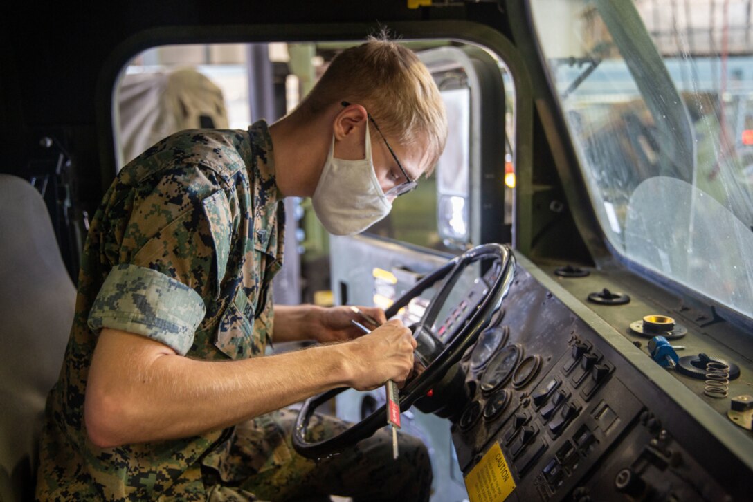 Cpl. Aiden Bemis, a digital manufacturing engineer with 1st Supply Battalion, 1st Marine Logistics Group, I Marine Expeditionary Force, measures the width of a steering wheel column at Marine Corps Base Camp Pendleton, April 29, 2021. Bemis provided the capability to mass produce a steering wheel remover tool that prevents damage to the steering wheel column during removal. The tool was originally designed by Staff Sgt. Kyle Owens, a motor transportation chief with Combat Logistics Battalion 5, 1st MLG. In 2012, after cracking multiple steering wheel columns using a slide hammer kit, he came up with the idea to drill three holes into a standard washer and weld a nut so that he could effectively remove a steering wheel from the Medium Tactical Vehicle Replacements and Logistics Vehicle System Replacements.