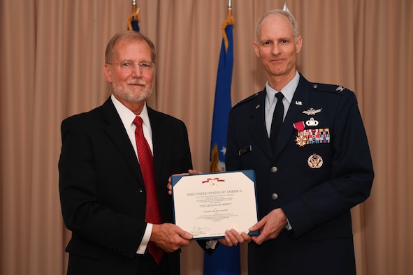 Steven Wert, program executive office Digital, headquartered at Hanscom Air Force Base, Mass., presents Col. Ryan Mantz with the Legion of Merit during his retirement ceremony June 11. Mantz, who had served as the deputy program executive officer for Digital since August 2017, retired after 29 years of service.