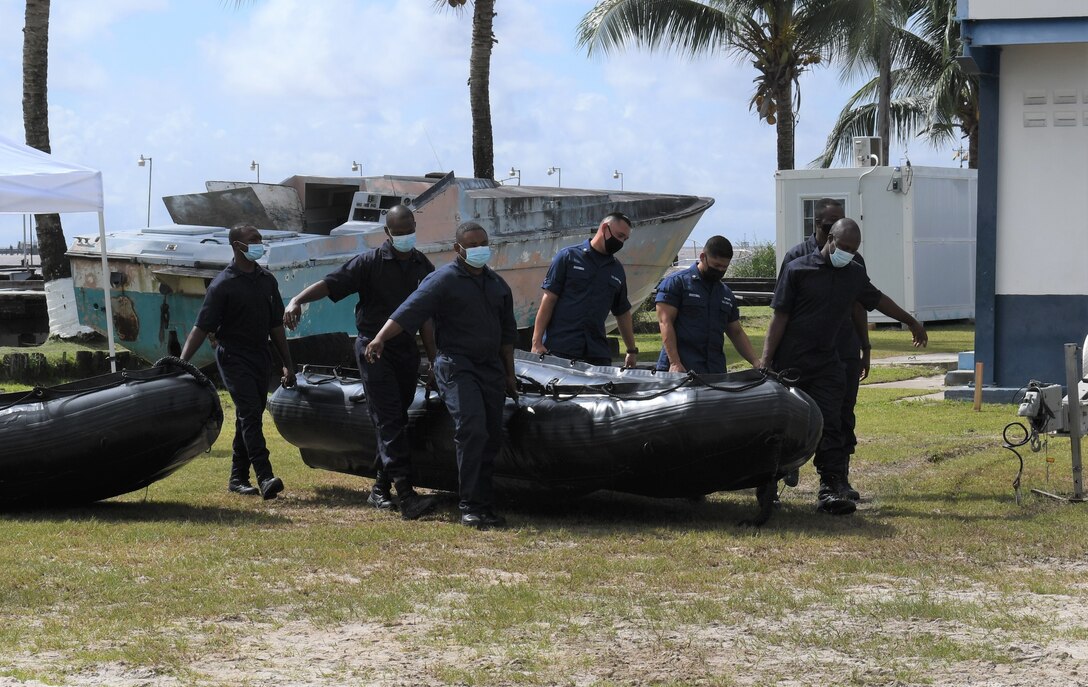 Coast Guardsmen from the U.S. and Guyana transport an inflatable small boat in preparation for exercises.