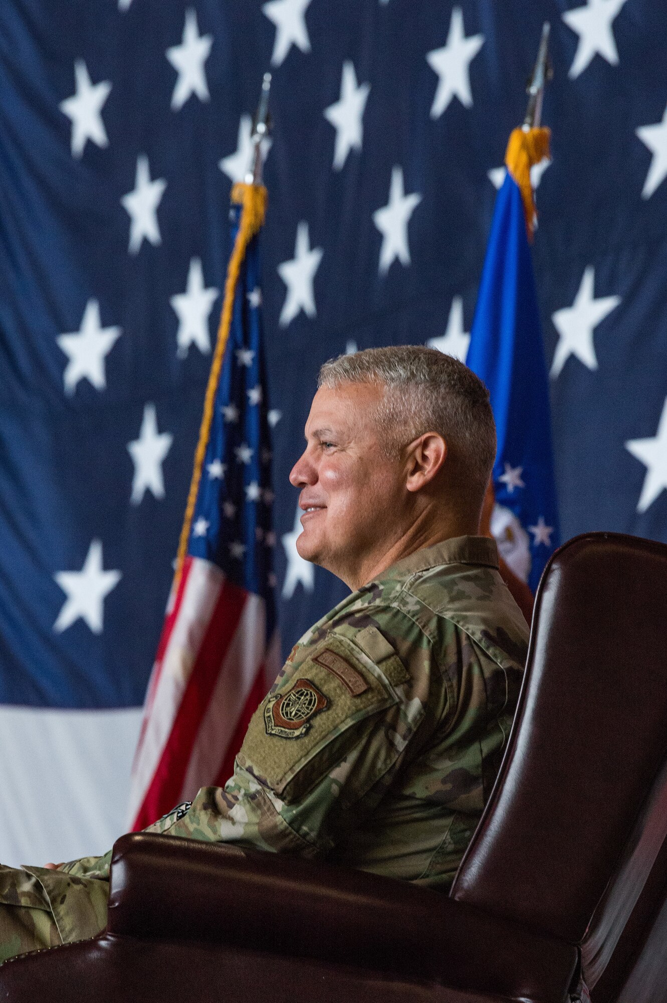 Col. Christopher May, 436th Maintenance Group commander, observes the audience during his retirement ceremony at Dover Air Force Base, Delaware, June 11, 2021. Retired Air Force Col. Norman Moore officiated the ceremony, which paid special tribute to May's distinguished career spanning 33 years of dedicated service to the nation. (U.S. Air Force photo by Roland Balik)