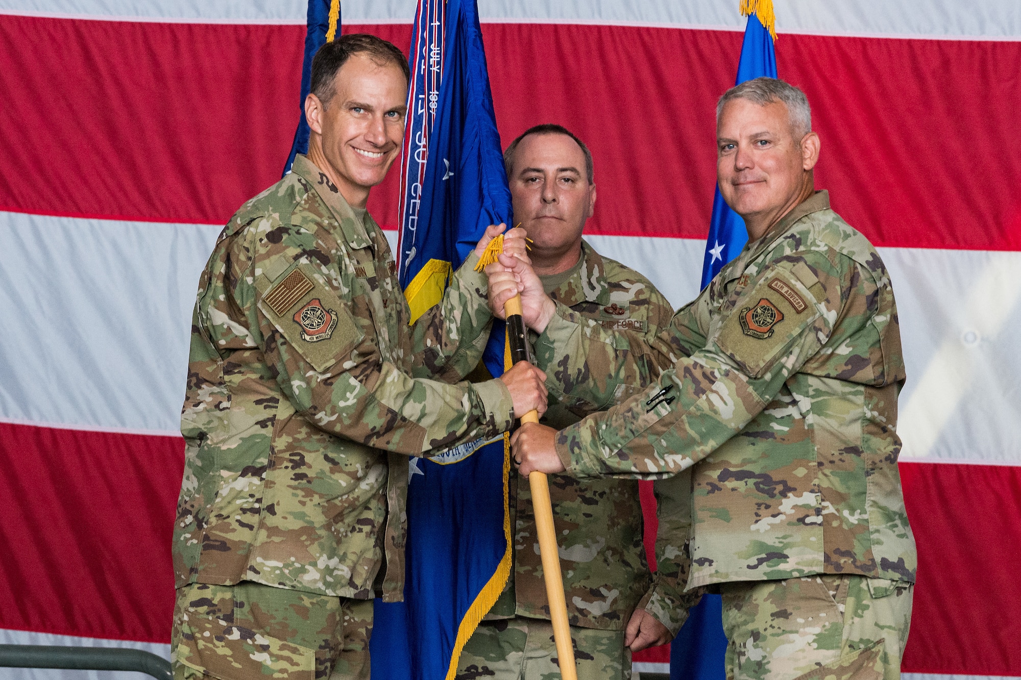 Col. Matt Husemann, left, 436th Airlift Wing commander, accepts the 436th Maintenance Group guidon from Col. Christopher May, 436th MXG commander, during the 436th MXG Change of Command ceremony on Dover Air Force Base, Delaware, June 11, 2021. May relinquished command to Col. Bary Flack. The 436th MXG supports the worldwide global mobility mission by providing trained maintenance specialists for two of the Air Force's cargo transport aircraft, the C-5M Super Galaxy and the C-17A Globemaster III. (U.S. Air Force photo by Roland Balik)