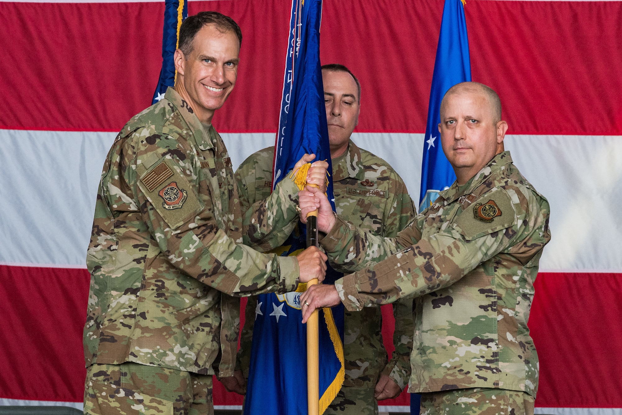 Col. Matt Husemann, left, 436th Airlift Wing commander, passes the 436th Maintenance Group guidon to Col. Bary Flack, new 436th MXG commander, during the 436th MXG Change of Command ceremony on Dover Air Force Base, Delaware, June 11, 2021. Flack took command from Col. Christopher May. The 436th MXG supports the worldwide global mobility mission by providing trained maintenance specialists for two of the Air Force's cargo transport aircraft, the C-5M Super Galaxy and the C-17A Globemaster III. (U.S. Air Force photo by Roland Balik)