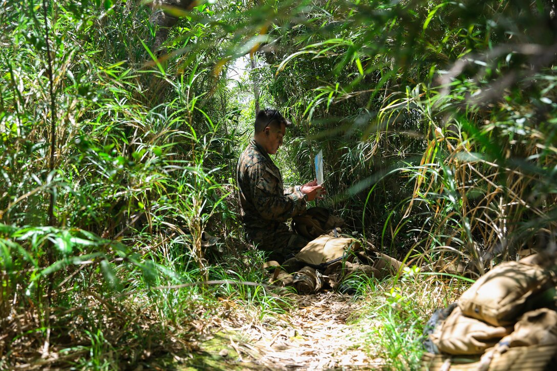 U.S. Marine Corps Staff Sgt. Tyler Ochs, a platoon commander with 1st Battalion, 6th Marine Regiment, currently attached to 3rd Marine Division under the Unit Deployment Program, sets up defensive positions during an Expeditionary Advance Base Operation exercise at the Northern Training Area, Okinawa, Japan, June 17, 2020. This 1st Battalion, 6th Marine Regiment-led exercise also features participation from 3rd Reconnaissance Battalion and High Mobility Artillery Rocket Systems from 3rd Battalion, 12th Marine Regiment. Training events like this strengthen 3rd Marine Division’s ability to control key terrain in a contested battlespace. Ochs is a native of Fond du Lac, Wisconsin