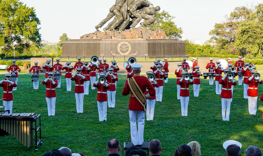 Master GySgt. Keith Martinez, drum major, “The Commandant’s Own,” U.S. Marine Drum and Bugle Corps, conducts the Marines during a Tuesday Sunset Parade at the Marine Corps War Memorial, Arlington, VA, June 15, 2021. The hosting official for the evening was Brig. Gen. Lorna Mahlock, Director, Information, Command, Control, Communications and Computers, and Ms. Gwynne Shotwell, President and Chief Operations Officer of SpaceX, was the guest of honor. (U.S. Marine Corps photo by Sgt. Jason Kolela)
