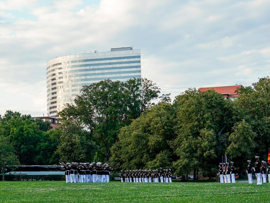 Marines with the Silent Drill Platoon execute their “bursting bomb” sequence during a Tuesday Sunset Parade at the Marine Corps War Memorial, Arlington, VA, June 15, 2021. The hosting official for the evening was Brig. Gen. Lorna Mahlock, Director, Information, Command, Control, Communications and Computers, and Ms. Gwynne Shotwell, President and Chief Operations Officer of SpaceX, was the guest of honor. (U.S. Marine Corps photo by Sgt. Jason Kolela)