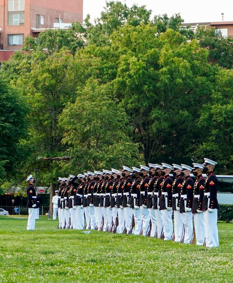 Marines with the Silent Drill Platoon execute their “rifle inspection” sequence during a Tuesday Sunset Parade at the Marine Corps War Memorial, Arlington, VA, June 15, 2021. The hosting official for the evening was Brig. Gen. Lorna Mahlock, Director, Information, Command, Control, Communications and Computers, and Ms. Gwynne Shotwell, President and Chief Operations Officer of SpaceX, was the guest of honor. (U.S. Marine Corps photo by Sgt. Jason Kolela)