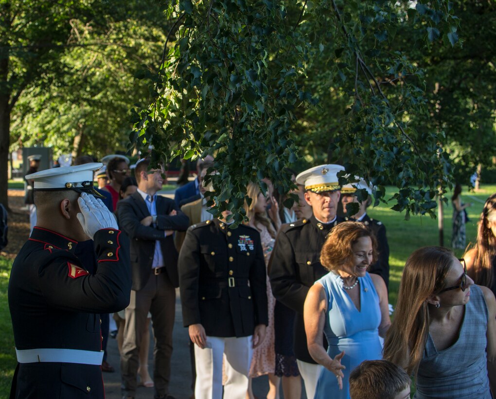 Lance Cpl. Victor Liconaacosta, hoster, H&S Company, Marine Barracks Washington, renders a salute while the official party passes during a Tuesday Sunset Parade at the Marine Corps War Memorial, Arlington, VA, June 15, 2021. The hosting official for the evening was Brig. Gen. Lorna Mahlock, Director, Information, Command, Control, Communications and Computers, and Ms. Gwynne Shotwell, President and Chief Operations Officer of SpaceX, was the guest of honor. (U.S. Marine Corps photo by Lance Cpl. Allen Sanders)