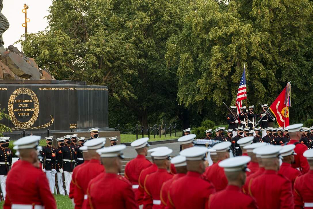 Marines with Marine Barracks Washington stand at the position of attention for the presentation of the colors during a Tuesday Sunset Parade at the Marine Corps War Memorial, Arlington, VA, June 15, 2021. The hosting official for the evening was Brig. Gen. Lorna Mahlock, Director, Information, Command, Control, Communications and Computers, and Ms. Gwynne Shotwell, President and Chief Operations Officer of SpaceX, was the guest of honor. (U.S. Marine Corps photo by Lance Cpl. Allen Sanders)