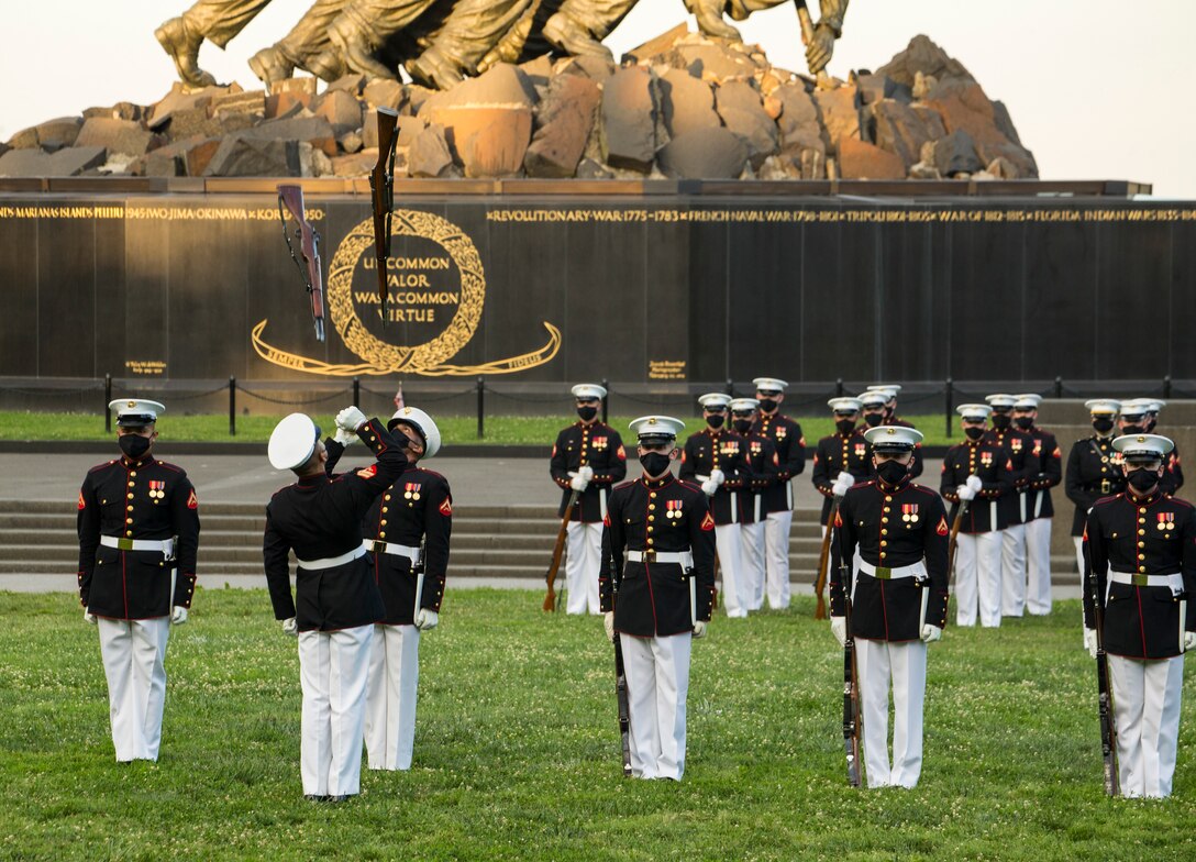 Marines with the Silent Drill Platoon execute their “rifle inspection” sequence during a Tuesday Sunset Parade at the Marine Corps War Memorial, Arlington, VA, June 15, 2021.