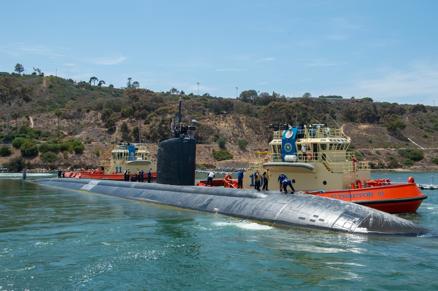 Sailors assigned to the Los Angeles-class fast-attack submarine USS Hampton (SSN 767) depart Naval Base Point Loma for a western Pacific deployment.