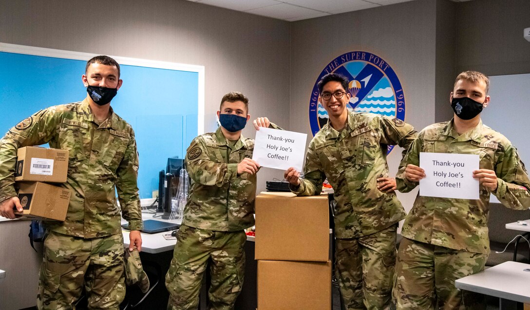 Airmen from the 436th Aerial Port Squadron thank Holy Joe’s Café for a shipment of donated coffee at Dover Air Force Base, Delaware, June 10, 2021. Holy Joe’s Café has sent free coffee to U.S. military bases since 2006. The organization partners with military chaplains to provide thousands of free cups of coffee to troops in 70 countries around the world. (U.S. Air Force photo by Airman 1st Class Stephani Barge)