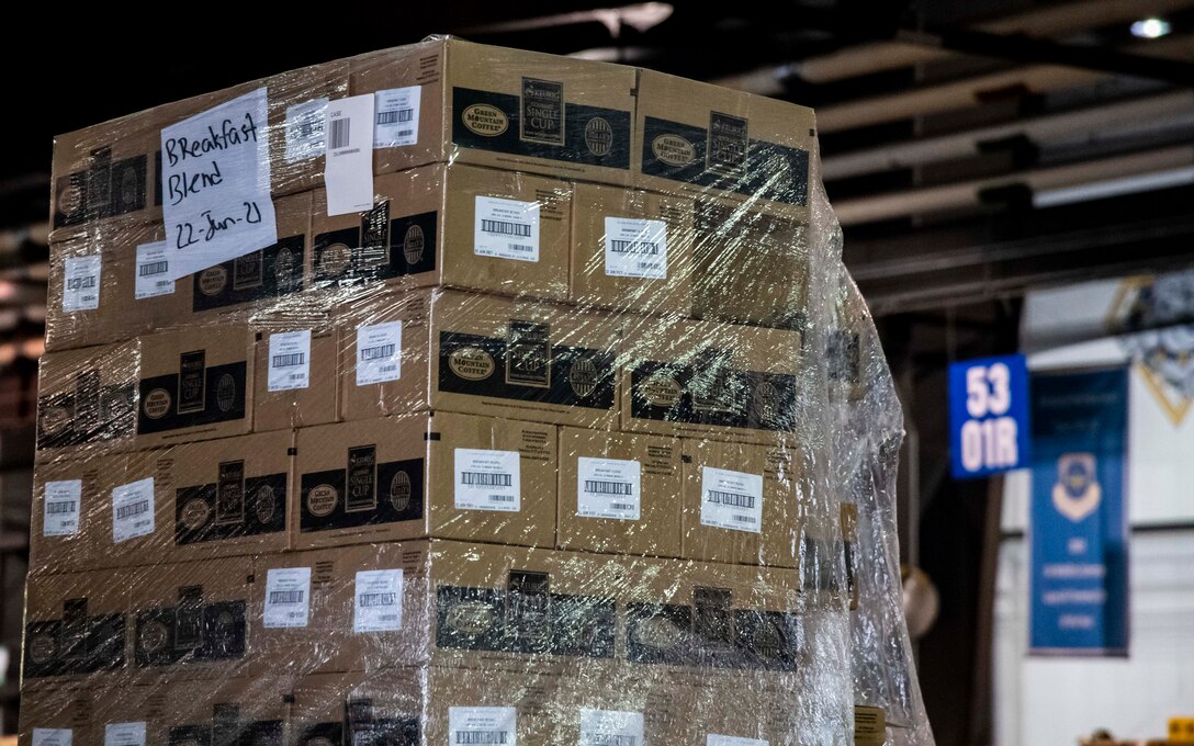 A pallet of donated coffee by Holy Joe’s Café sits in the 436th Aerial Port Squadron warehouse at Dover Air Force Base, Delaware, June 10, 2021. Holy Joe’s Café has sent free coffee to U.S. military bases since 2006. They work with military chaplains to provide thousands of free cups of coffee to troops in 70 countries throughout the world. (U.S. Air Force photo by Airman 1st Class Stephani Barge)