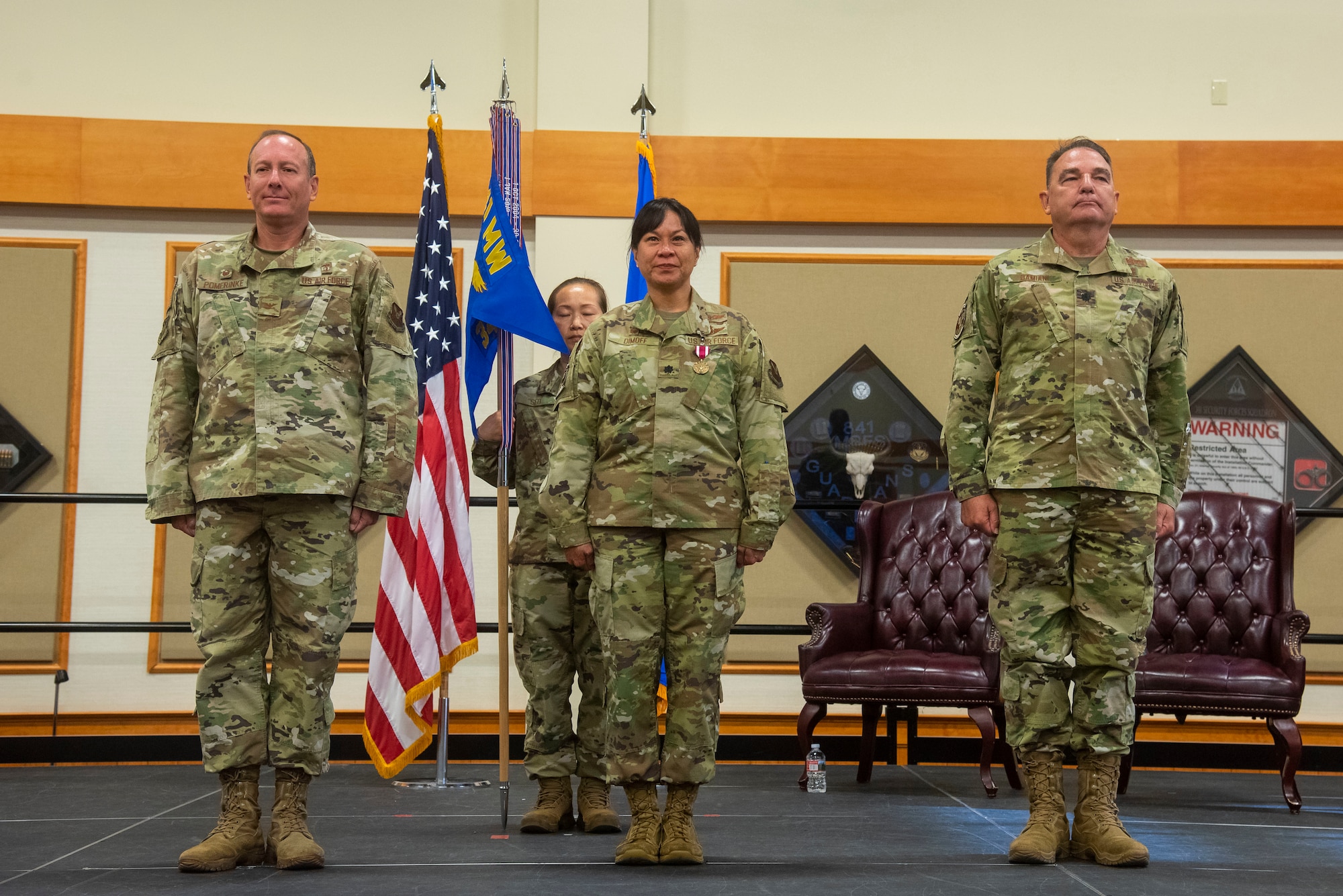 From left, Col. Mark Pomerinke, 341st Medical Group commander; Lt. Col. Michelle Dimoff, 341st Operational Medical Readiness Squadron outgoing commander; and Lt. Col. Darren Damiani, 341st OMRS incoming commander, await the ceremonial portion of a change of command at Malmstrom Air Force Base, Mont., June 16, 2021.