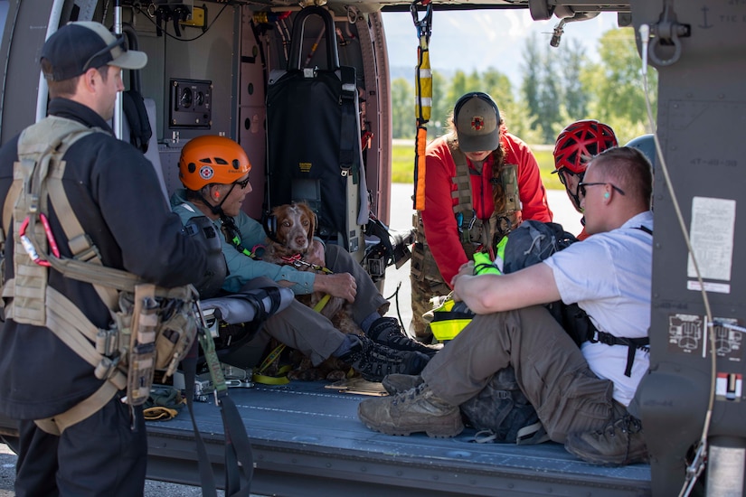 Pilots and crew members of the Alaska Army National Guard's 1st Battalion, 207th Aviation Regiment prepare to fly ground search and rescue teams with Alaska Mountain Rescue Group and MAT+SAR Search & Rescue to various locations on Pioneer Peak near Palmer, AK, to search for a missing hiker, June 15, 2021. (U.S. Army National Guard photo by Spc. Grace Nechanicky)